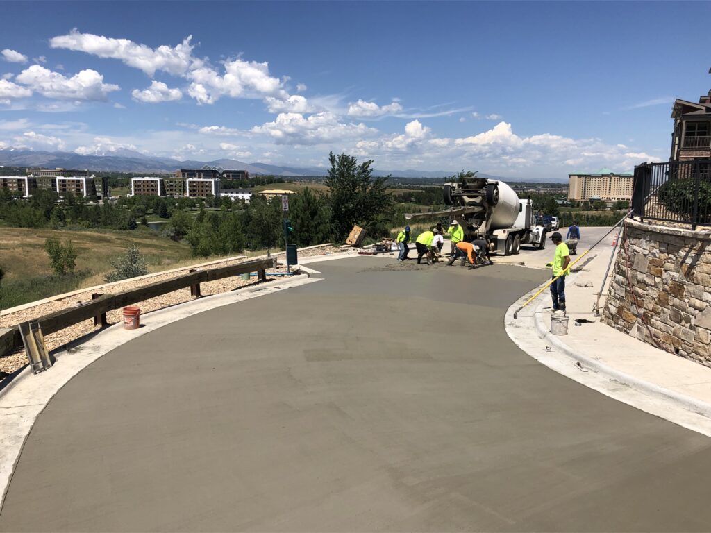 Concrete crew pouring a large replacement slab along the Colorado foothills
