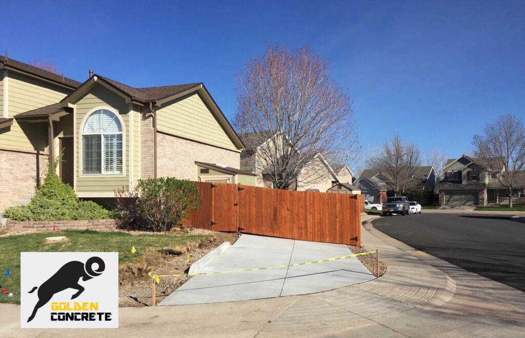 New concrete driveway apron and side parking pad at a Colorado home