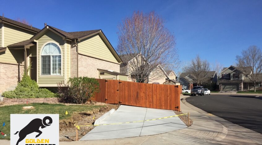 New concrete driveway apron and side parking pad at a Colorado home