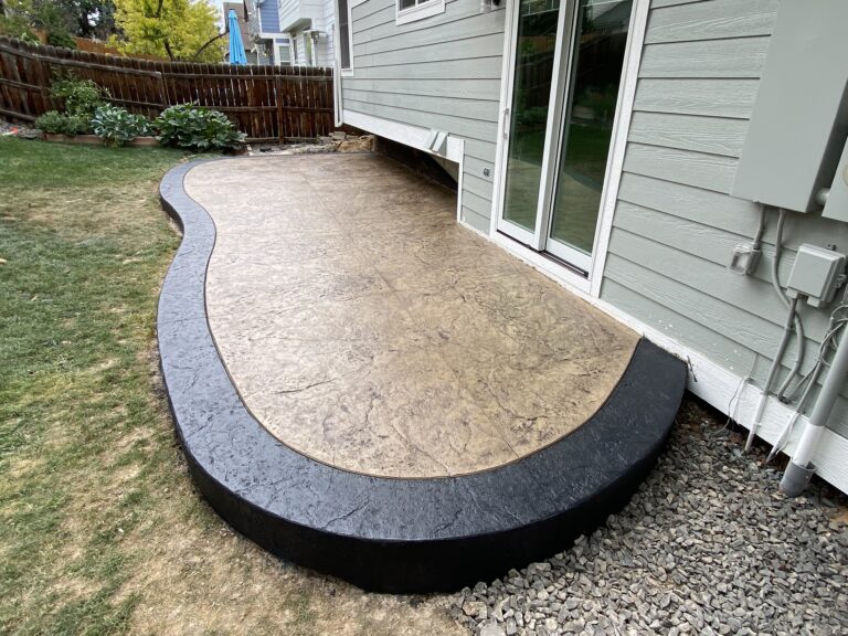 Stamped concrete patio with a dark stained border