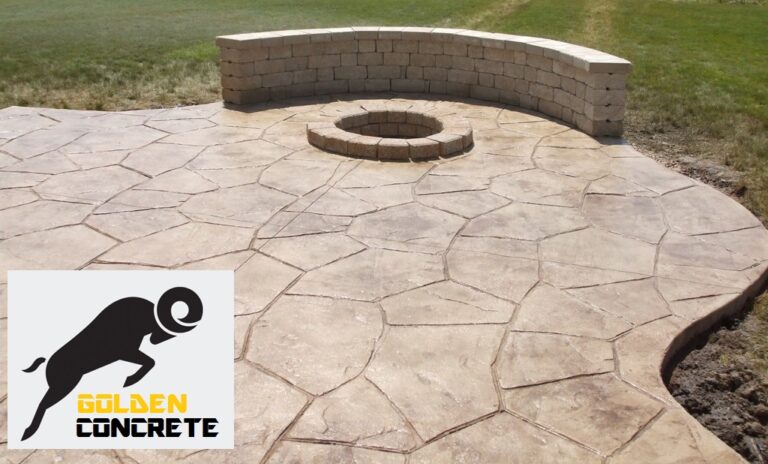 Stamped concrete patio with a sitting wall and fire pit