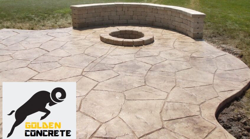 Stamped concrete patio with a sitting wall and fire pit