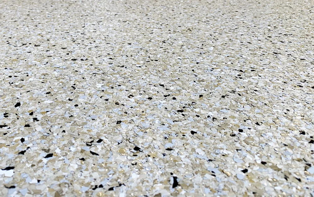 Close-up of a tan and black flake epoxy floor coating